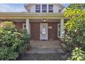 Inviting front porch with brick accents, decorative plants, and a clear view of the home's entrance at 8974, 8972 & 8970 Nc 90 E Hwy, Stony Point, NC 28678