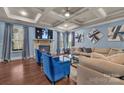 Elegant living room with stone fireplace, coffered ceiling, and ample seating at 9032 Cornflower Dr, Harrisburg, NC 28075