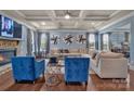Stylish living room with a stone fireplace, coffered ceiling, and hardwood floors at 9032 Cornflower Dr, Harrisburg, NC 28075