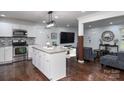 Modern kitchen features granite counters, a stainless steel oven, and white cabinets at 1121 Rembrandt Sw Dr, Concord, NC 28027