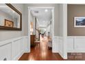 Inviting hallway with hardwood floors and white wainscoting, leading to a bright and spacious living area at 1320 Huntcliff Dr, Waxhaw, NC 28173