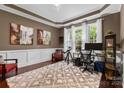 Cozy home office with stylish decor, a large window for natural light, and hardwood floors at 1320 Huntcliff Dr, Waxhaw, NC 28173