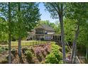 Beautiful home nestled among mature trees, boasting a large lawn and scenic views of the surrounding nature at 1328 Astoria Pkwy, Catawba, NC 28609