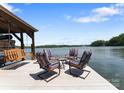 Relaxing waterfront dock featuring comfortable seating and a swing for enjoying scenic lake views at 1328 Astoria Pkwy, Catawba, NC 28609