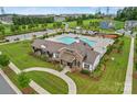 Stunning aerial view of the community pool and clubhouse, surrounded by manicured lawns and ample parking at 13756 Roderick Dr # 176, Huntersville, NC 28078