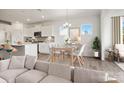 Bright, open-concept living space with modern decor, a dining area, and a view of the well-equipped kitchen at 13756 Roderick Dr # 176, Huntersville, NC 28078
