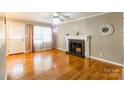 Inviting living room featuring hardwood floors, fireplace, and abundant natural light at 1400 Fern Forest Dr, Gastonia, NC 28054
