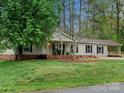 Charming single-story home with a brick foundation, vinyl siding, covered front porch, and carport at 141 Hickory Creek Dr, Gastonia, NC 28052