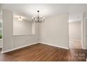 Open dining room with hardwood floors, modern chandelier, and neutral paint creating an elegant space at 1532 Hunt Club Ct, Rock Hill, SC 29732