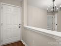 Bright foyer features a white door, modern lighting, and a glimpse into the home's interior at 1532 Hunt Club Ct, Rock Hill, SC 29732