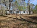 Exterior view of house with blue shutters, set on a spacious, tree-filled lot at 1586 Brook Ln, Denver, NC 28037