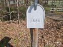 Close up of weathered white mailbox for 1587 Brook Lane at 1586 Brook Ln, Denver, NC 28037
