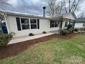 Well-maintained single-story home with freshly mulched garden beds and a paved walkway at 1628 B Se Ave, Hickory, NC 28602