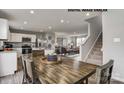 Open-concept living space showcasing a modern kitchen, dining area, and inviting living room with staircase access at 169 Basildon St # 1012, Lancaster, SC 29720