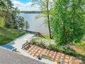 Elevated deck offers stunning views of the lake, complemented by lush greenery and a cozy outdoor space at 1720 Gaither Rd, Belmont, NC 28012