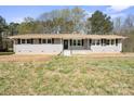 Charming single-story home features a newly painted exterior, a well-maintained lawn, and a welcoming front porch at 174 Maske Rd, Mount Gilead, NC 27306