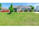 Inviting single-story home featuring a manicured lawn and a welcoming front porch with traditional design elements at 1805 Lawton Dr, Rock Hill, SC 29730
