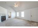 Spacious living room with a fireplace, a ceiling fan, and natural light from multiple windows at 1805 Lawton Dr, Rock Hill, SC 29730