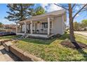 A charming single-story home with a covered front porch, set amidst a lush, landscaped yard at 207 Kerr Nw St, Concord, NC 28025