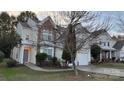 Inviting two-story home with stone accents, manicured lawn, and attached garage at 2125 Arbor Vista Dr, Charlotte, NC 28262