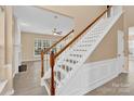 Bright foyer with staircase and hardwood floors leading into the living area at 2125 Arbor Vista Dr, Charlotte, NC 28262