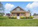 Inviting home with a classic design, green lawn, and beautiful shrubbery at 307 Jaida Ln, Oakboro, NC 28129