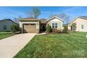 Well-manicured lawn and landscaping surrounding this charming single-story home with a one-car garage at 314 Flat Rock Dr, Denver, NC 28037