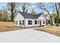 Well-lit view of the home's exterior, showing a driveway and manicured lawn on a sunny day at 315 Club House Dr, Salisbury, NC 28144