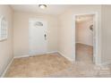 Welcoming foyer with tiled flooring, a white front door, and an open doorway to another room at 3254 Pikes Peak Dr, Gastonia, NC 28052