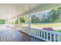 Spacious covered front porch with white railings and views of the surrounding landscape at 3921 Bon Rea Dr, Charlotte, NC 28226