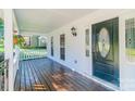 Inviting front porch with wooden flooring, decorative door, and ample natural light at 3921 Bon Rea Dr, Charlotte, NC 28226
