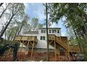 Multi-level deck with stairs provides outdoor living space and access to backyard, surrounded by trees at 4125 Hemingway Dr, Hickory, NC 28601