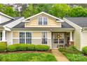 Charming townhouse with well-manicured landscaping, inviting front porch, and classic architectural details at 413 Lexie Ln # 92, Rock Hill, SC 29732