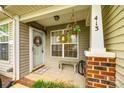 Charming front porch with a welcome wreath, seating bench, and well-maintained column at 413 Lexie Ln # 92, Rock Hill, SC 29732