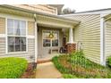 Inviting front porch features brick accents, a welcome sign, and space for seating, creating a cozy entry at 413 Lexie Ln # 92, Rock Hill, SC 29732
