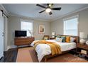 Comfortable main bedroom with ceiling fan, neutral walls, stylish decor, and warm natural light at 4429 Major St, Charlotte, NC 28208