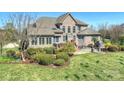 Expansive backyard featuring a stone fire pit, patio, and mature trees at 516 White Tail Ter, Waxhaw, NC 28173