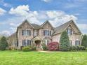 Charming brick home with a well-maintained lawn and mature trees at 516 White Tail Ter, Waxhaw, NC 28173