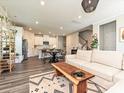 Open-concept living room with kitchen, dining area, and hardwood floors at 533 Cedar Knoll Cir, Pineville, NC 28134