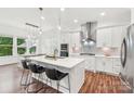 Modern kitchen featuring an island with bar seating, stainless steel appliances, and pendant lighting at 6006 Waxhaw Crossing Dr, Waxhaw, NC 28173