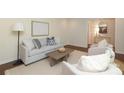 Comfortable living room featuring a soft gray sofa, accent chairs, and stylish decor at 6036 Sharon Acres Rd, Charlotte, NC 28210
