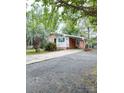 Exterior view of a charming brick home with a convenient carport and well-kept grounds at 6115 Amberly Ln, Charlotte, NC 28213