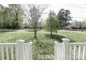 Inviting front yard with a well maintained lawn and view of the neighborhood street and other houses at 6124 Old Plank Rd, Charlotte, NC 28216