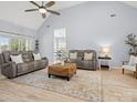 Spacious living room featuring vaulted ceiling, modern sofas, stylish rug, and ample natural light at 621 Summey Farm Dr, Dallas, NC 28034