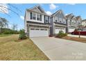 Charming two-story home featuring a stone facade, attached two-car garage, and a well-manicured lawn at 6563 Kinder Ln, Lancaster, SC 29720