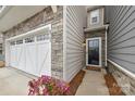 Inviting entrance features a stylish front door, stone accents, and meticulously landscaped surroundings at 6563 Kinder Ln, Lancaster, SC 29720