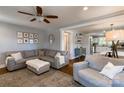 Inviting living room featuring hardwood floors, grey sectional, and open layout at 702 Hazel Ave, Kannapolis, NC 28083