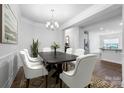 Elegant dining room with modern chandelier, seating for six, and stylish decor at 7186 Barleywood Dr, Locust, NC 28097