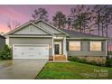 Charming single-Gathering home with an attached garage and a well-maintained lawn at 7186 Barleywood Dr, Locust, NC 28097