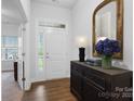 Inviting foyer with hardwood floors, decorative mirror, and an elegant entry table at 7186 Barleywood Dr, Locust, NC 28097